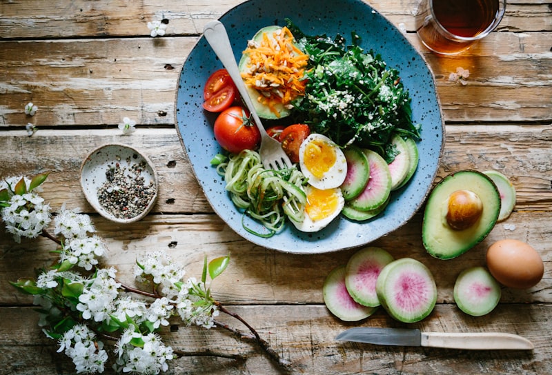 Overhead grain bowl garnished with fresh vegetables